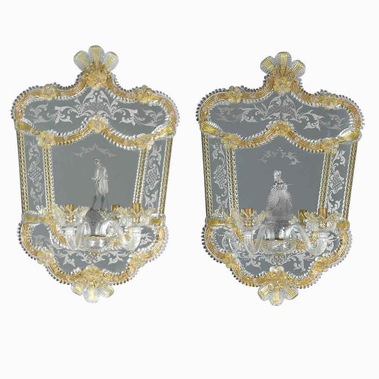 coppia di specchi veneziani con luci inciso a mano con dama e cavaliere sulla lastra centrale, ricci, foglie e fiori in vetro di murano colore cristallo su fondo oro